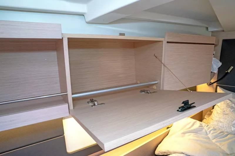 Slide: The Image of Interior storage of 2022 Beneteau Oceanis 461 yacht with open wooden cabinets. - 29