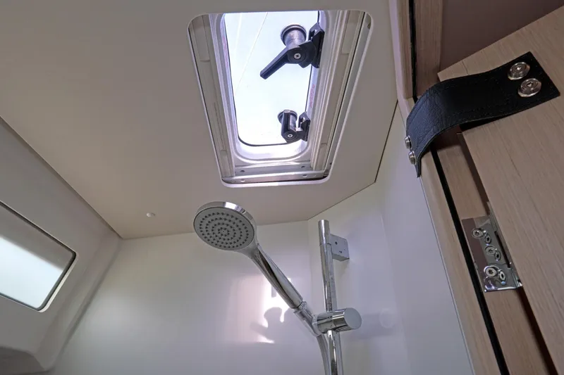 Slide: The Image of Interior of 2022 Beneteau Oceanis 461 yacht bathroom with shower and skylight. - 31