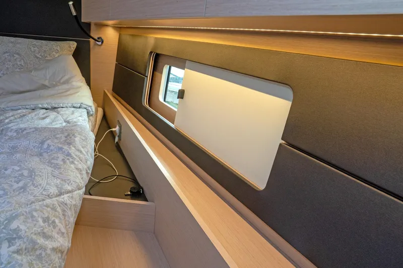 Slide: The Image of Interior cabin of 2022 Beneteau Oceanis 461 yacht with bed and window. - 35