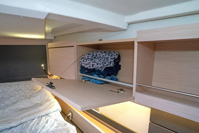 Slide: The Image of Cozy cabin interior of 2022 Beneteau Oceanis 461 with open storage and bedding. - 38