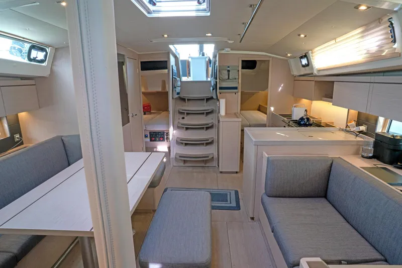 Slide: The Image of Interior of 2022 Beneteau Oceanis 461 yacht, featuring modern seating and kitchen area. - 4