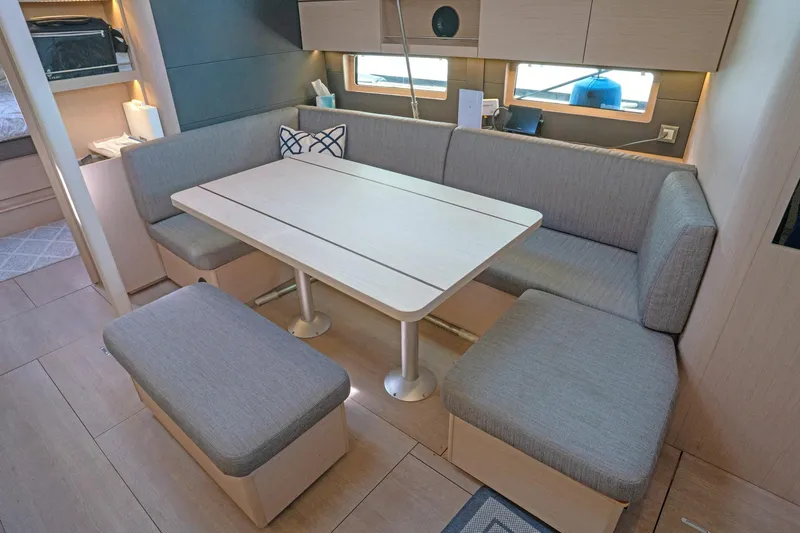 Slide: The Image of Modern interior of 2022 Beneteau Oceanis 461 yacht with cozy seating and dining area. - 5