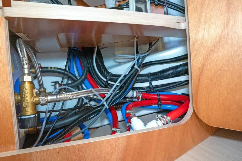 Slide: The Image of Beneteau Oceanis 461 2022 yacht plumbing system with colorful pipes and fittings. - 50
