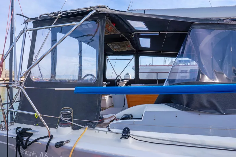 Slide: The Image of 2022 Beneteau Oceanis 461 sailboat with covered cockpit, docked in marina. - 57