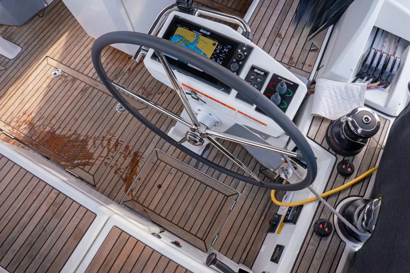 Slide: The Image of Cockpit of 2022 Beneteau Oceanis 461 sailboat with steering wheel and navigation controls. - 58