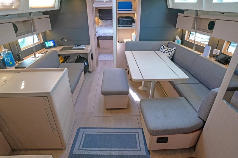 Slide: The Image of Interior of 2022 Beneteau Oceanis 461 yacht, featuring modern seating and dining area. - 6