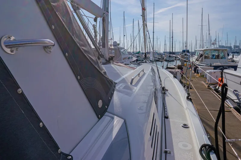 Slide: The Image of 2022 Beneteau Oceanis 461 yacht docked at marina, surrounded by other boats. - 61