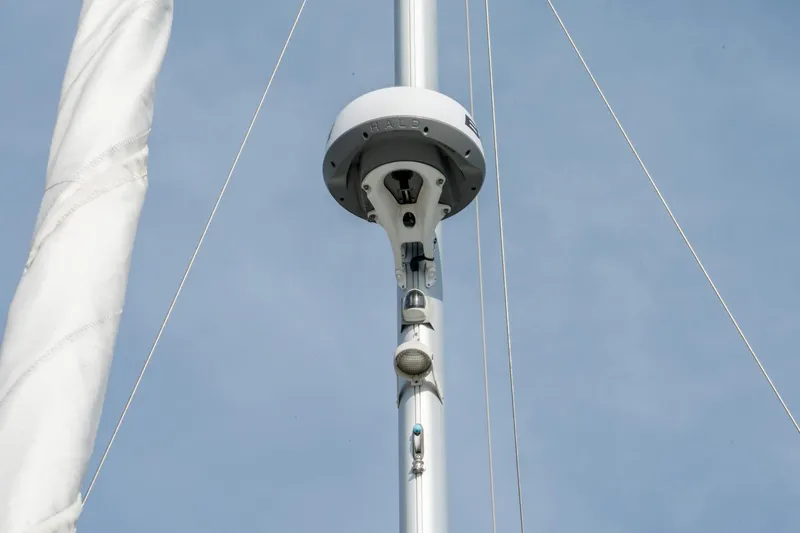 Slide: The Image of Mast of 2022 Beneteau Oceanis 461 sailboat with radar and rigging against blue sky. - 66