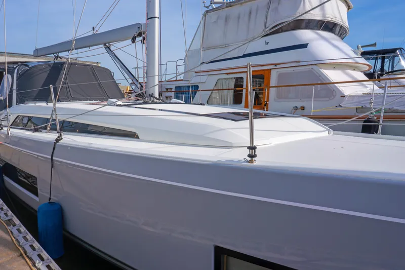 Slide: The Image of 2022 Beneteau Oceanis 461 sailboat docked at marina, showcasing sleek design and modern features. - 74