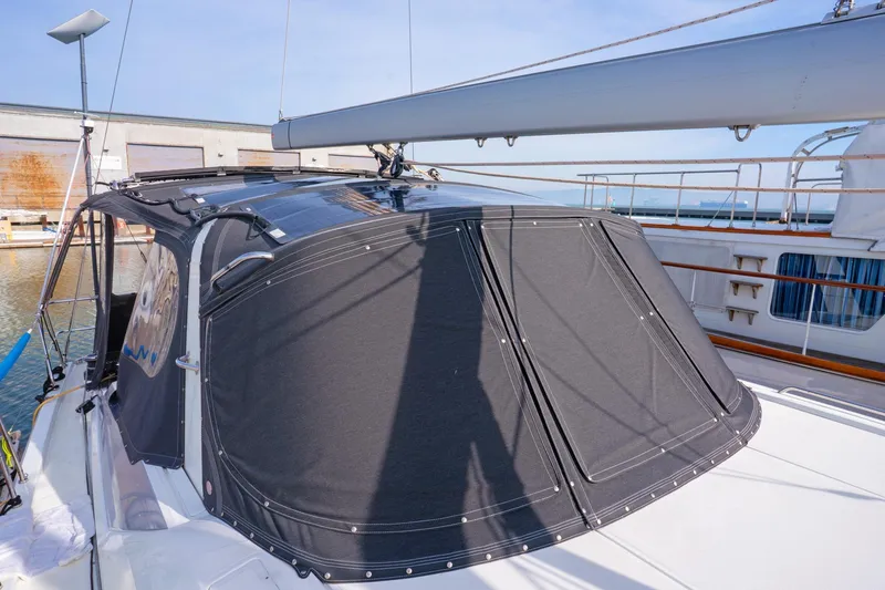 Slide: The Image of 2022 Beneteau Oceanis 461 sailboat with covered cockpit, docked at marina. - 80