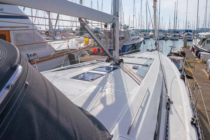 Slide: The Image of Beneteau Oceanis 461 sailboat, 2022 model, docked in a marina with other boats. - 81