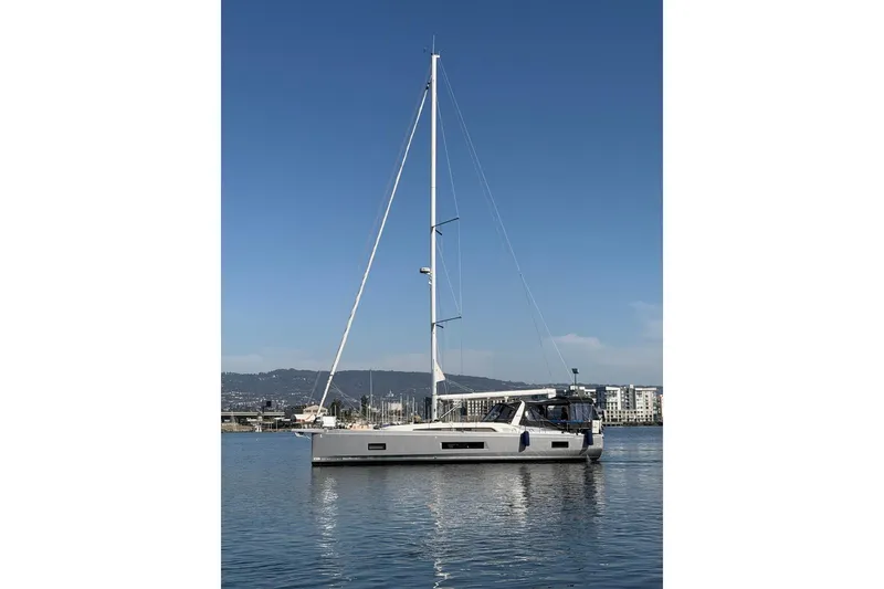 Slide: The Image of 2022 Beneteau Oceanis 461 sailboat on calm water, clear sky background. - 83