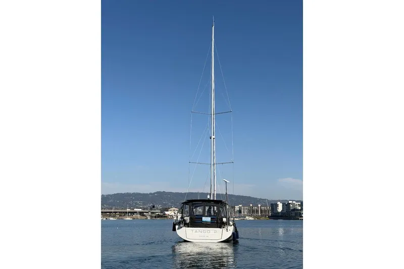 Slide: The Image of 2022 Beneteau Oceanis 461 sailboat on calm water, clear blue sky background. - 84