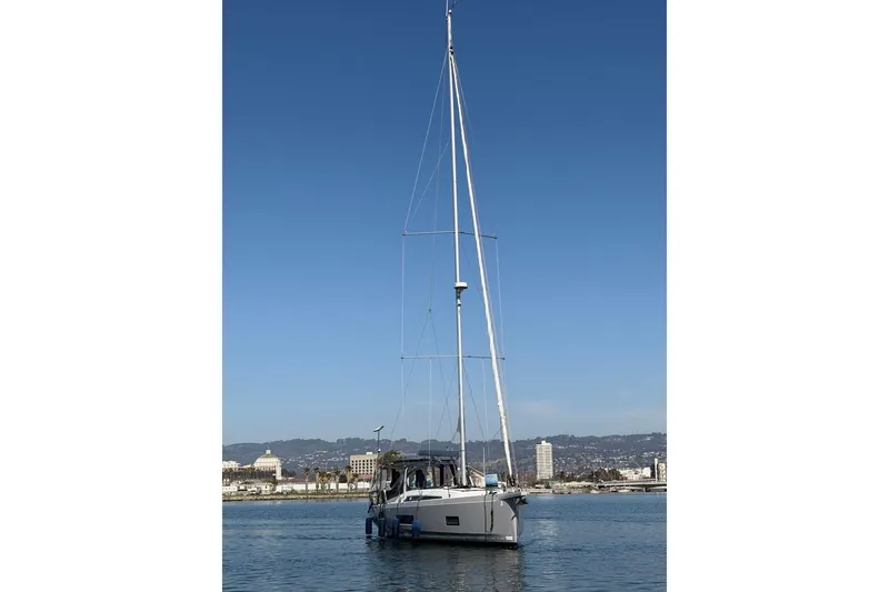 Slide: The Image of Sailing yacht Beneteau Oceanis 461, 2022 model, on calm water with cityscape background. - 85