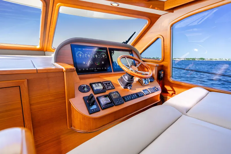 Slide: The Image of Luxurious 2020 Palm Beach Motor Yachts PB55 helm with wooden accents and modern navigation displays. - 15