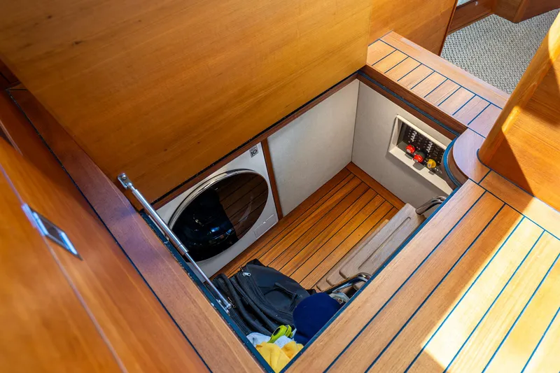 Slide: The Image of 2020 Palm Beach Motor Yachts PB55 interior with laundry area and wooden flooring. - 17