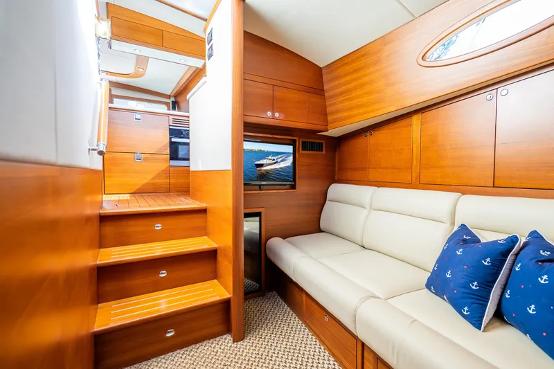 Slide: The Image of Luxurious 2020 Palm Beach Motor Yachts PB55 interior with wooden finish and comfortable seating. - 18