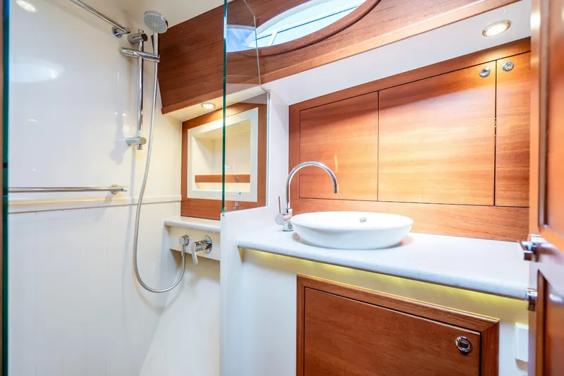 Slide: The Image of Luxurious bathroom in 2020 Palm Beach Motor Yachts PB55, featuring modern fixtures and elegant wood accents. - 29