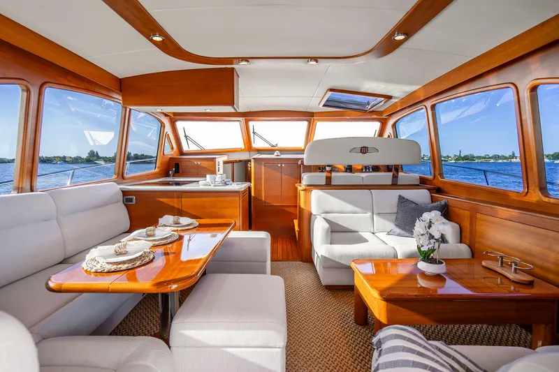 Slide: The Image of Luxurious interior of 2020 Palm Beach Motor Yachts PB55, featuring elegant wood finishes and plush seating. - 4
