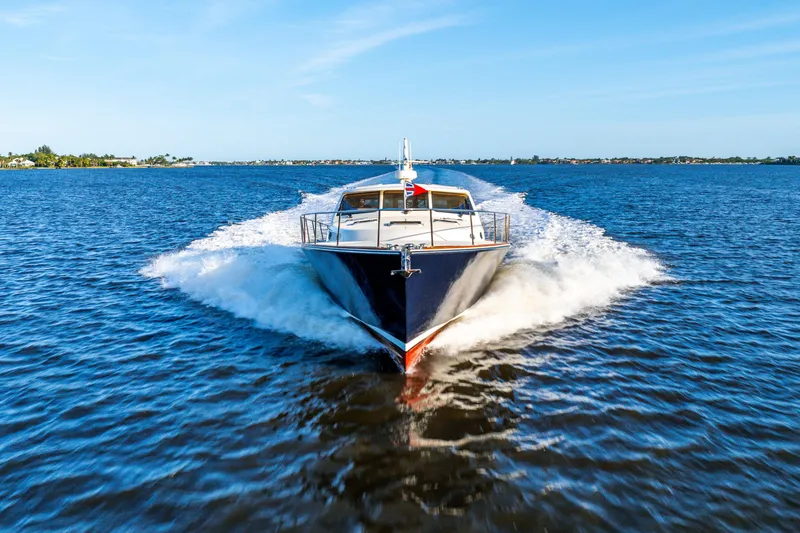 Slide: The Image of 2020 Palm Beach Motor Yachts PB55 cruising on open water, showcasing sleek design and performance. - 45