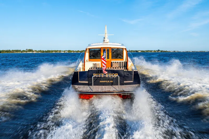 Slide: The Image of 2020 Palm Beach Motor Yachts PB55 cruising on open water, rear view. - 46