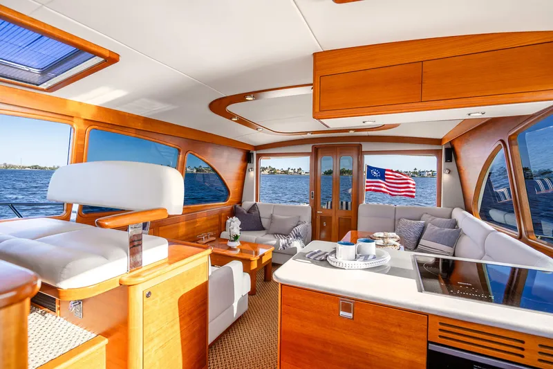 Slide: The Image of Luxurious interior of 2020 Palm Beach Motor Yachts PB55 with elegant wood finish and scenic water view. - 10