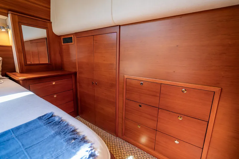 Slide: The Image of Luxurious wooden interior of 2020 Palm Beach Motor Yachts PB55, featuring elegant cabinetry and mirror. - 23