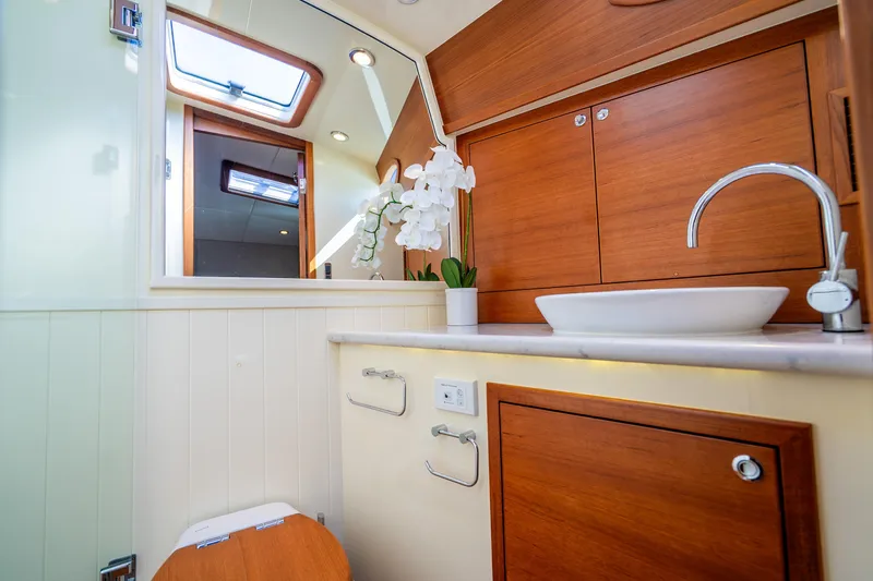 Slide: The Image of Luxurious bathroom in 2020 Palm Beach Motor Yachts PB55, featuring elegant wood cabinetry and modern fixtures. - 25