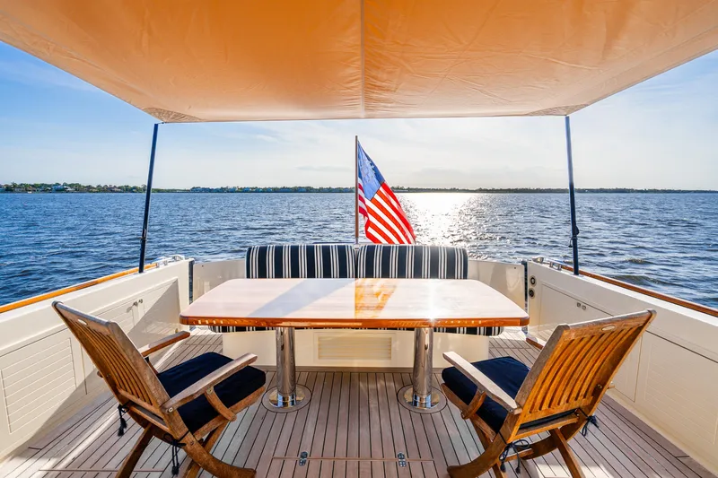 Slide: The Image of Luxurious 2020 Palm Beach Motor Yachts PB55 deck with seating, table, and ocean view. - 33