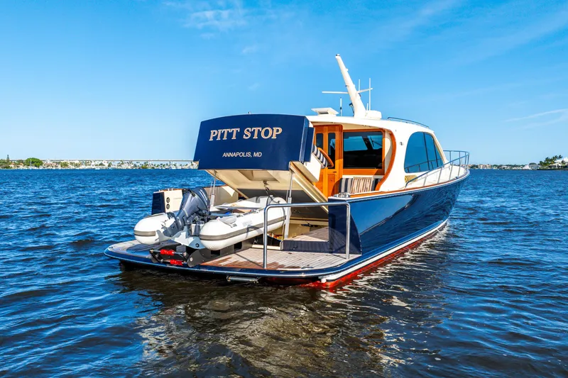 Slide: The Image of 2020 Palm Beach Motor Yachts PB55 on water, rear view, sunny day, "Pitt Stop" name visible. - 39