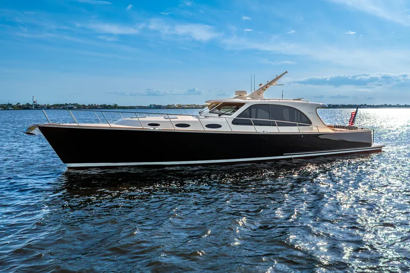 Slide: The Image of 2020 Palm Beach Motor Yachts PB55 cruising on a sunny day, reflecting on the water. - 41