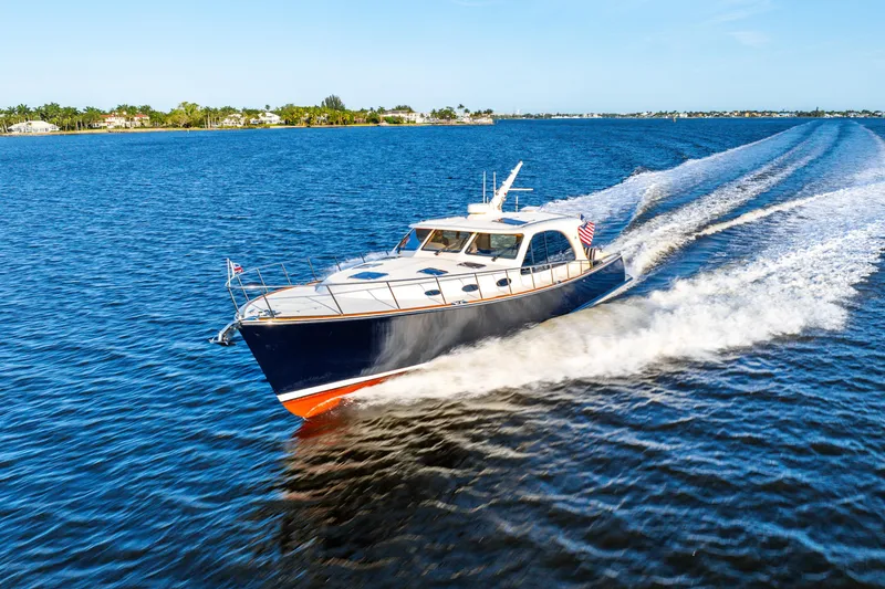 Slide: The Image of 2020 Palm Beach Motor Yachts PB55 cruising on open water, creating a dynamic wake. - 47