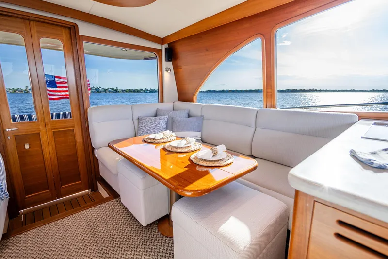 Slide: The Image of Luxurious interior of 2020 Palm Beach Motor Yachts PB55 with elegant dining area and scenic view. - 9