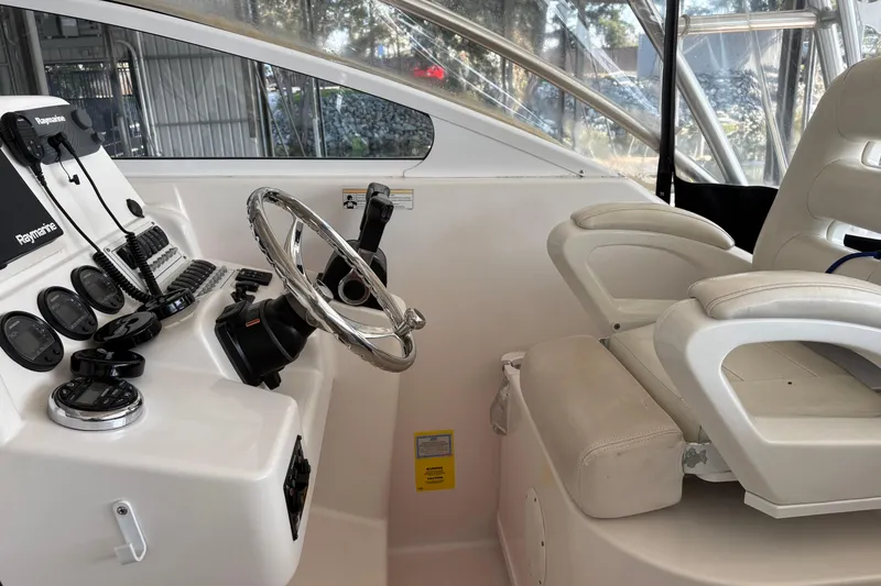 Slide: The Image of 2006 Pro-Line 32 Express boat helm with steering wheel and control panel. - 11