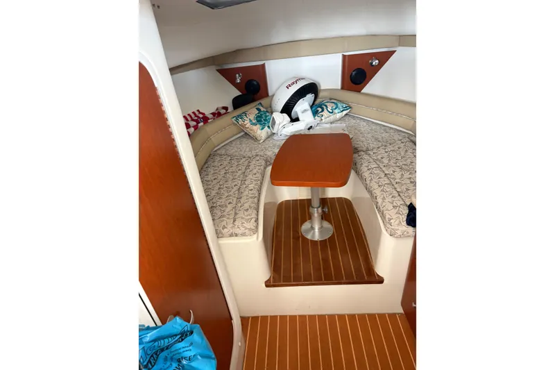 Slide: The Image of 2006 Pro-Line 32 Express cabin interior with cushioned seating and wooden table. - 12