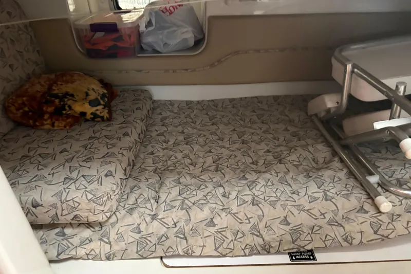 Slide: The Image of 2006 Pro-Line 32 Express cabin interior with patterned bedding and storage space. - 14