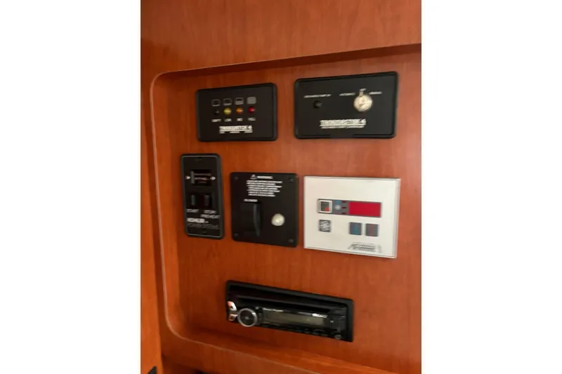 Slide: The Image of Control panel of 2006 Pro-Line 32 Express boat with various switches and displays. - 15