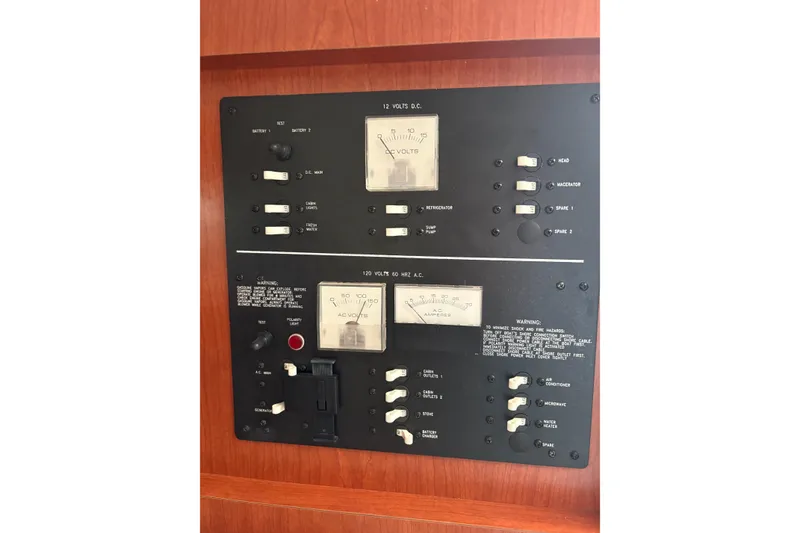 Slide: The Image of Electrical panel of 2006 Pro-Line 32 Express boat with voltage and amperage meters. - 16