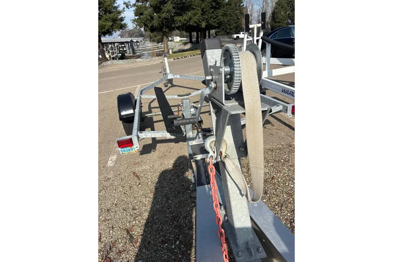 Slide: The Image of Trailer for 2006 Pro-Line 32 Express boat, featuring winch and chain mechanism. - 19