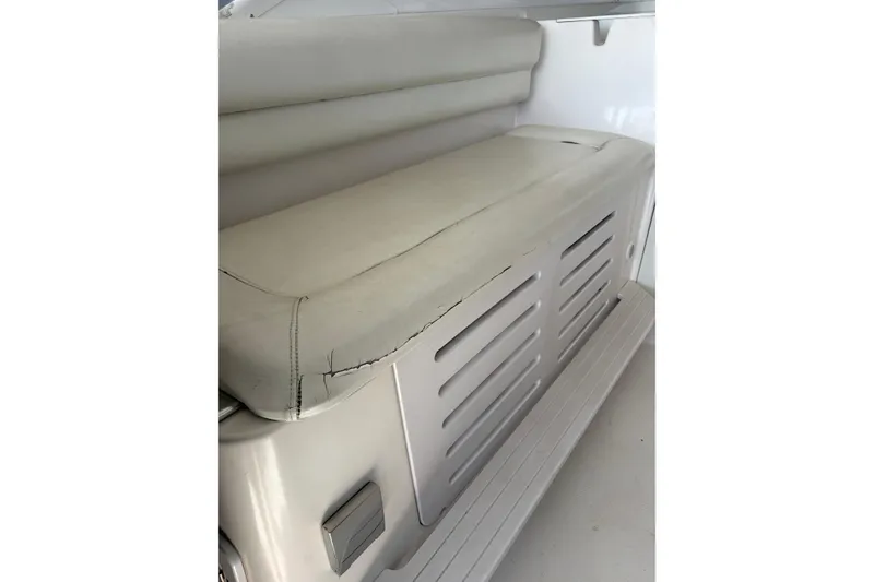 Slide: The Image of 2006 Pro-Line 32 Express boat seat with visible wear and cracks. - 8