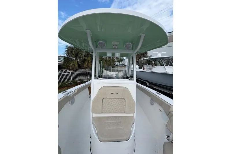 Slide: The Image of 2023 Sea Pro 259 DLX boat with T-top and cushioned seating. - 10