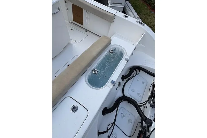 Slide: The Image of 2023 Sea Pro 259 DLX boat interior with seating and storage compartments. - 11