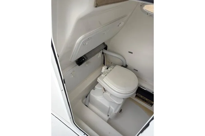 Slide: The Image of 2023 Sea Pro 259 DLX boat interior with compact marine toilet. - 12
