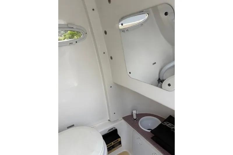 Slide: The Image of 2023 Sea Pro 259 DLX boat interior with sink and toilet. - 13