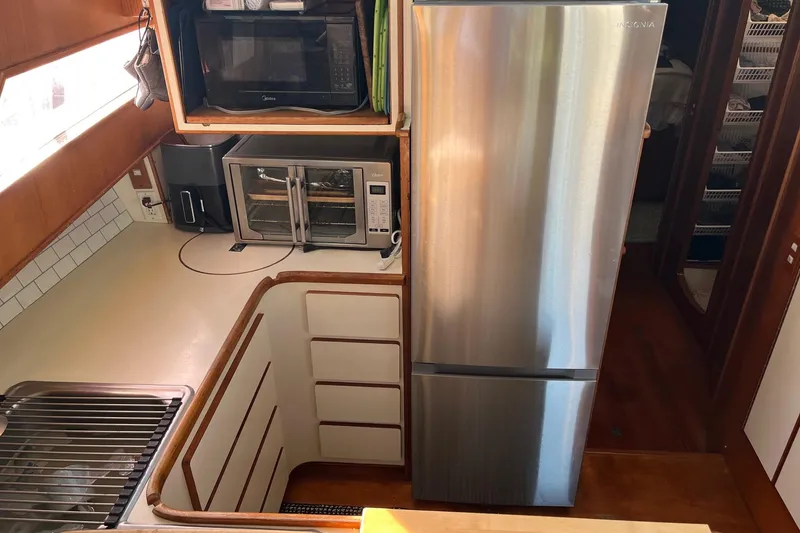 Slide: The Image of Luxurious interior of 1990 Mikelson 48 Sportfisher with plush seating and elegant decor. - 13