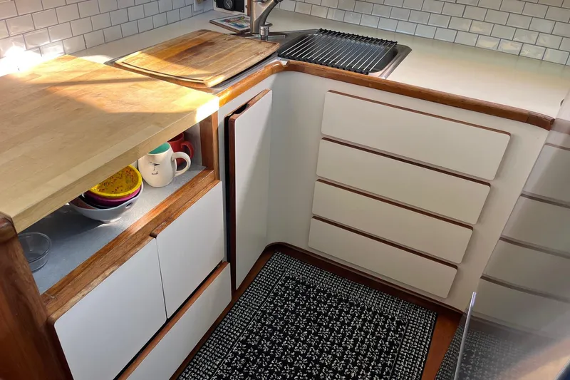 Slide: The Image of 1990 Mikelson 48 Sportfisher kitchen with wood countertops and modern appliances. - 15