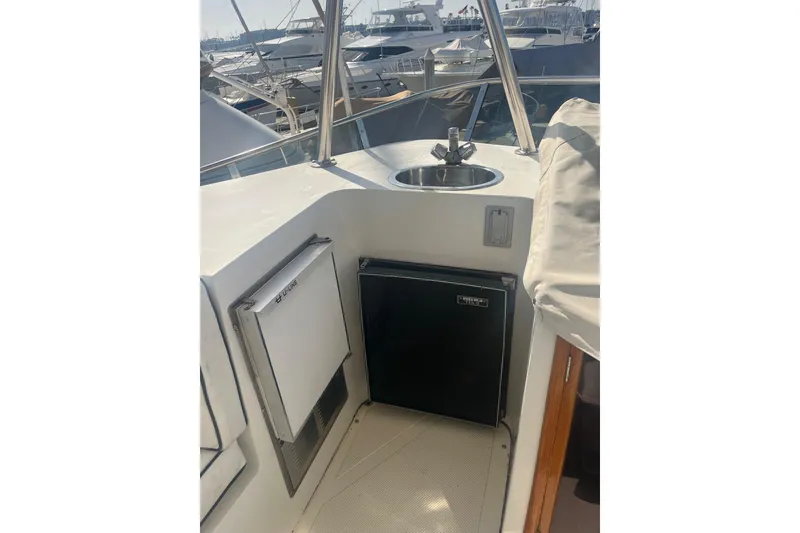 Slide: The Image of 1990 Mikelson 48 Sportfisher yacht with sink and mini fridge on deck. - 6