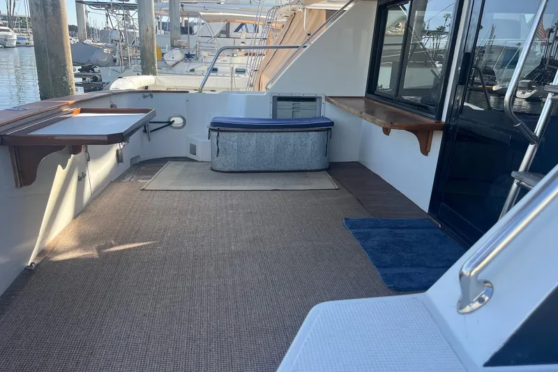 Slide: The Image of Spacious deck of 1990 Mikelson 48 Sportfisher yacht, featuring seating and storage. - 9