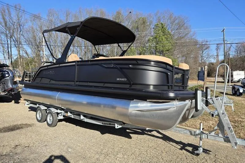 The Image of 2026 Godfrey Monaco 235 SFL pontoon boat on trailer, parked outdoors. - 0
