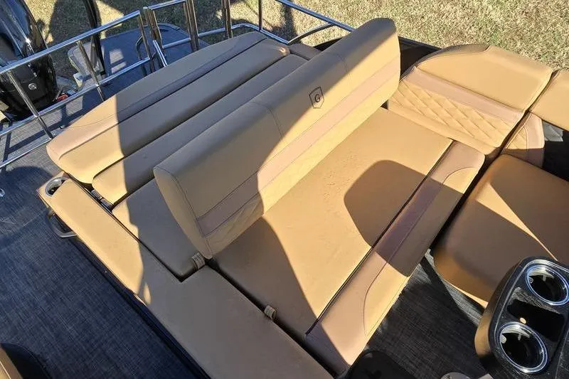 Slide: The Image of 2026 Godfrey Monaco 235 SFL boat with tan seating and cup holders. - 11